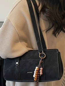 Retro black Boston shoulder bag with chic ethnic beaded tassel and gold lettering