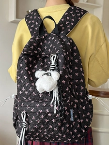 Black quilted backpack with pink bows and plush bear pendant for college women