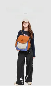 Close-up of tricolor nylon backpack with orange, blue, and cream waterproof panels