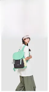Detail of mint green and black drawstring backpack with durable nylon fabric