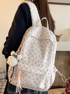 Cute white bubble fabric backpack with pink bows and a plush teddy bear charm