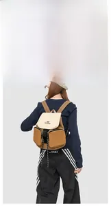 Detail view of water-resistant two-tone backpack with buckle closure and side pockets