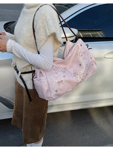 Detail of pink faux leather tote bag with whimsical horse and star prints