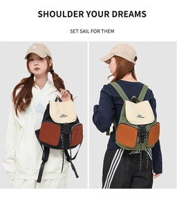 Detail view of large waterproof backpack with multi-color splicing and clip closure