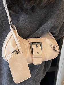 Vintage beige crescent motorcycle bag with pleated texture and silver hardware