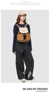 Detail view of the two-tone canvas backpack featuring a secure flap closure and front pockets