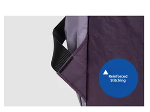 Detail of reinforced bartack stitching on a purple nylon outdoor backpack handle