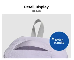 Detail view of the light purple backpack featuring durable grey nylon webbing handles