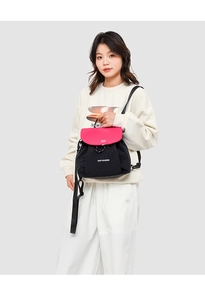 Detail of drawstring flap backpack in black and pink nylon featuring branded logo