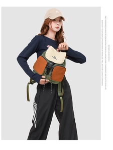Detail view of large capacity waterproof backpack with khaki and orange color blocking