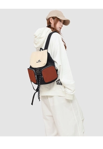 Detail view of large waterproof tri-color canvas backpack on a female model