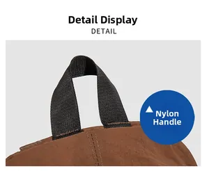Detailed close-up showing the durable nylon carry handle and brown fabric of the backpack