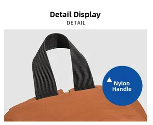 Detail view of the durable black nylon carry handle and fabric texture on a casual backpack