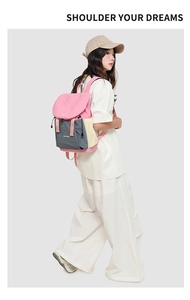 Detail view of stylish drawstring backpack with pink, grey and yellow patchwork design