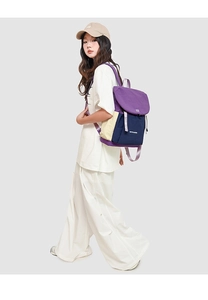 Casual drawstring backpack in purple and navy colorblock shown on a model