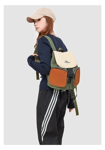 Detail view of large capacity waterproof backpack with color block design on female model