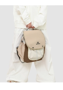 Close-up of khaki and brown patchwork backpack with flap closure and branded logo