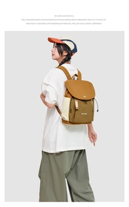 Detail view of double-decker nylon backpack in earth-tone colors for daily commute