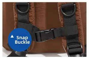 Detail of durable brown nylon backpack featuring adjustable chest strap and plastic buckle