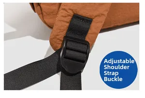 Detail of adjustable shoulder strap buckle on a crinkled nylon outdoor backpack