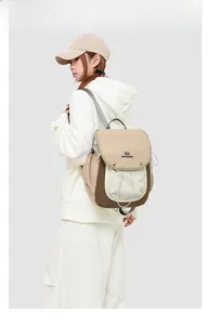 Detail of multi-color nylon backpack with drawstring closure and brand logo