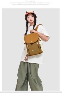Detail view of the drawstring double-decker canvas backpack in a stylish earth-tone colorway
