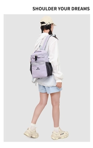 Rear view of a lilac and black water-resistant backpack with grey mesh pocket and straps