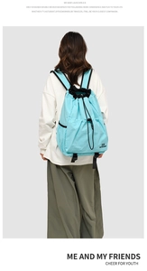 Rear view of a light blue waterproof drawstring backpack with double layers for travel