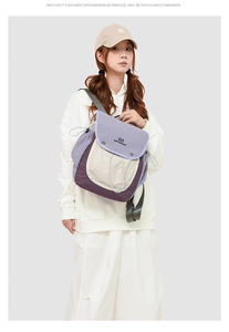 Detail of vintage college style backpack featuring purple and beige patchwork with drawstring