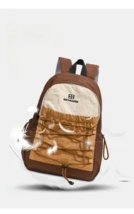 Detail of outdoor backpack featuring brown bungee cord and lightweight nylon fabric