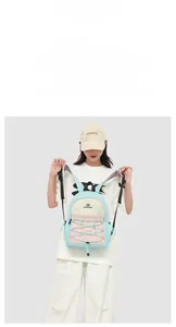 Detail view of the blue and pink color-block backpack with functional bungee cord and drawstring