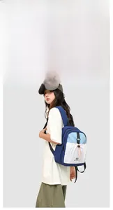 Detail view of a color-block outdoor backpack with blue and white patchwork design