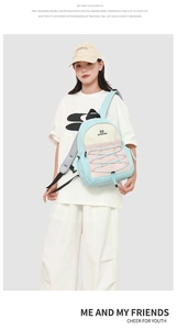 Detail of light blue and pink backpack featuring breathable grey mesh shoulder straps