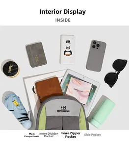 Vue à plat montrant les compartiments intérieurs spacieux et les objets dans le sac à dos gris