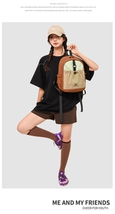 Detail of color-block backpack showing front drawstring pocket and brand logo