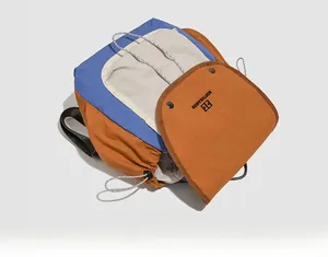 Detail of multi-color backpack showing drawstring closure and brand logo on orange flap