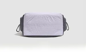 Detail view showing the flat wide base and black drawstring buckle of the purple backpack