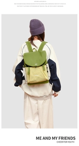 Close-up of green and beige waterproof nylon backpack with Nordmans logo and side pocket