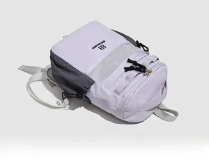 Detail of the water-resistant purple and grey backpack with mesh side pocket and logo