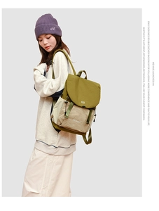 Detail of army green and beige nylon backpack featuring drawstring closure and side pockets