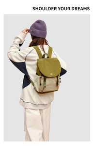 Detail view of stylish drawstring backpack in olive green and beige on a model's back