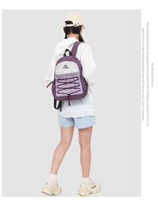 Detail of outdoor purple backpack with elastic drawstring and durable nylon fabric