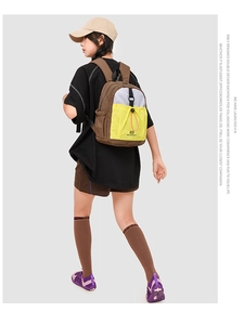 Detail of multi-color backpack showing drawstring pocket and double decker design