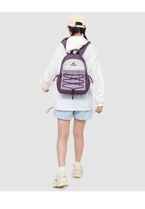 Detail of the purple and grey nylon backpack featuring criss-cross elastic bungee cords