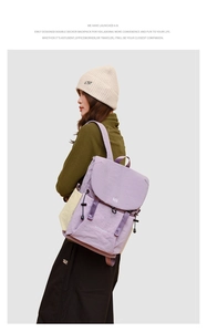 Detail view of purple drawstring backpack showing crinkled nylon texture and side pocket