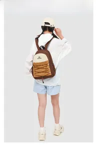 Close-up of contrast color backpack featuring elastic cross drawstrings and fabric texture