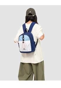 Detail shot of the Northansen color-block backpack worn by a model in a studio setting