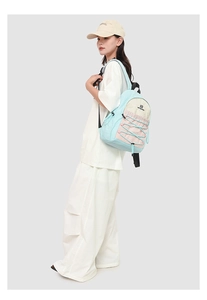 Detailed side view of colorful pastel backpack featuring front elastic bungee cords