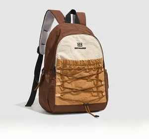 Detail of outdoor backpack featuring criss-cross drawstrings and breathable mesh straps