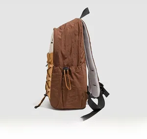 Side view of lightweight beige and brown hiking backpack with breathable mesh straps